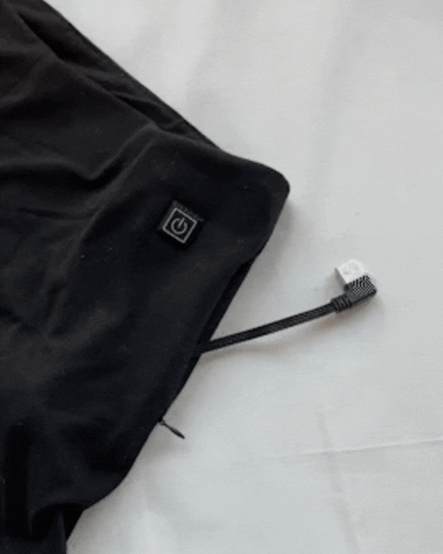 Image showing how to connect power bank into Sundaze Heated Shorts compartment. 